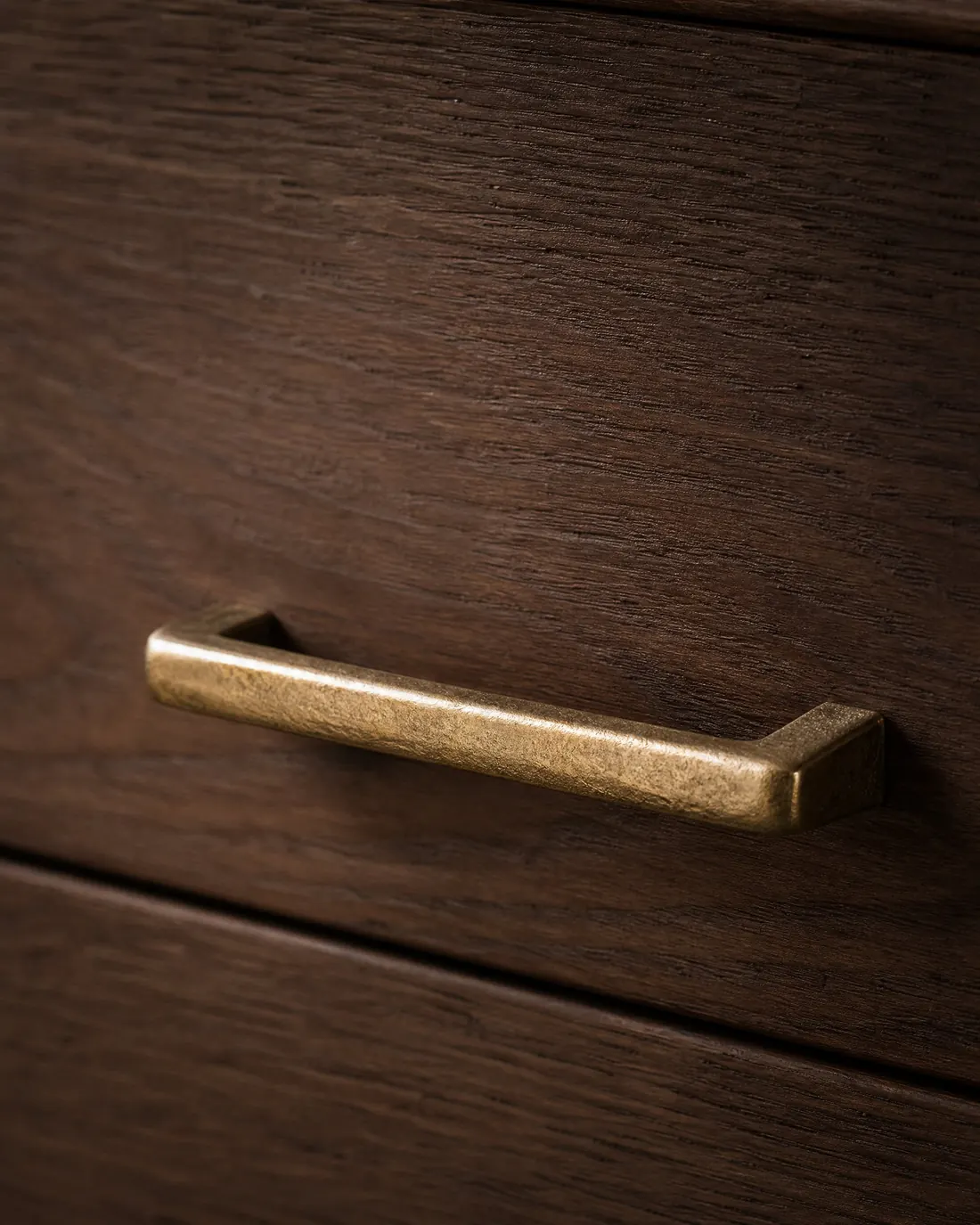 Hand-cast solid brass drawer pull on stained walnut