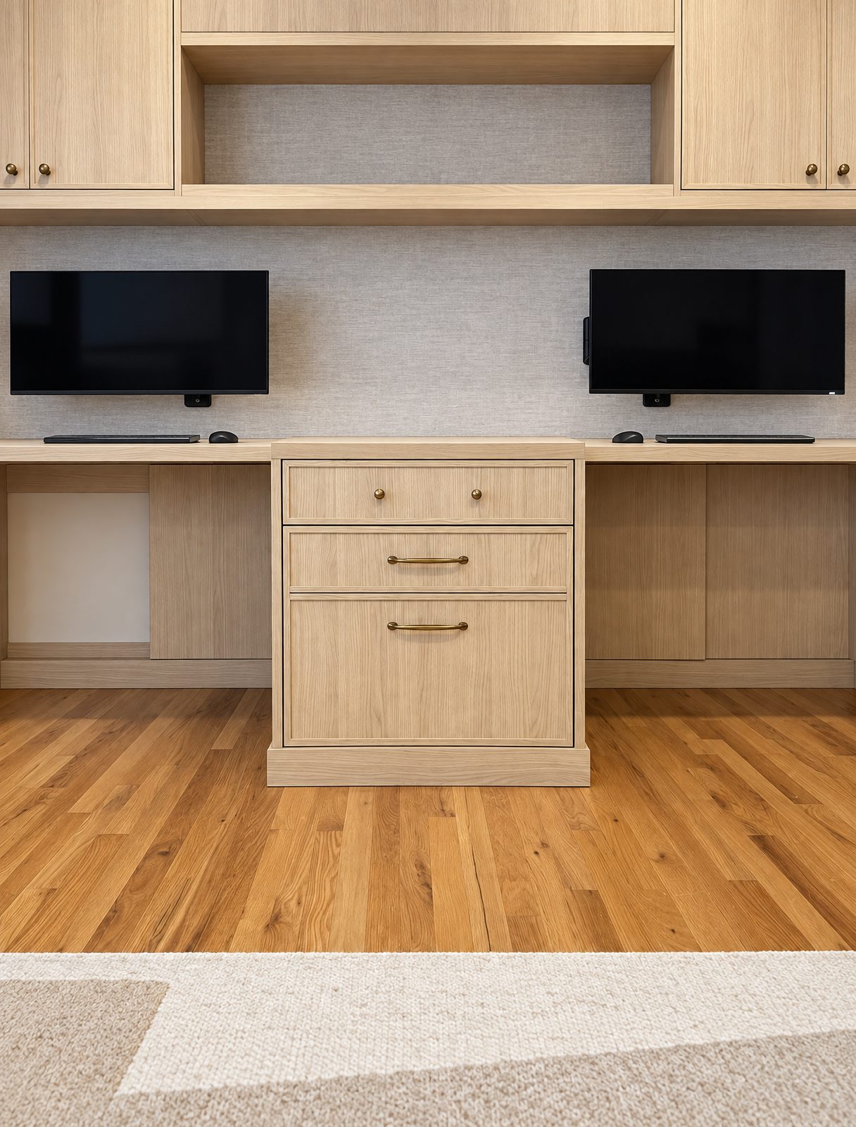 White oak home office wall with two desks, a center drawer stack and open storage above