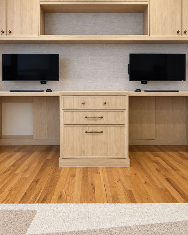 White oak home office wall with two desks, a center drawer stack and open storage above