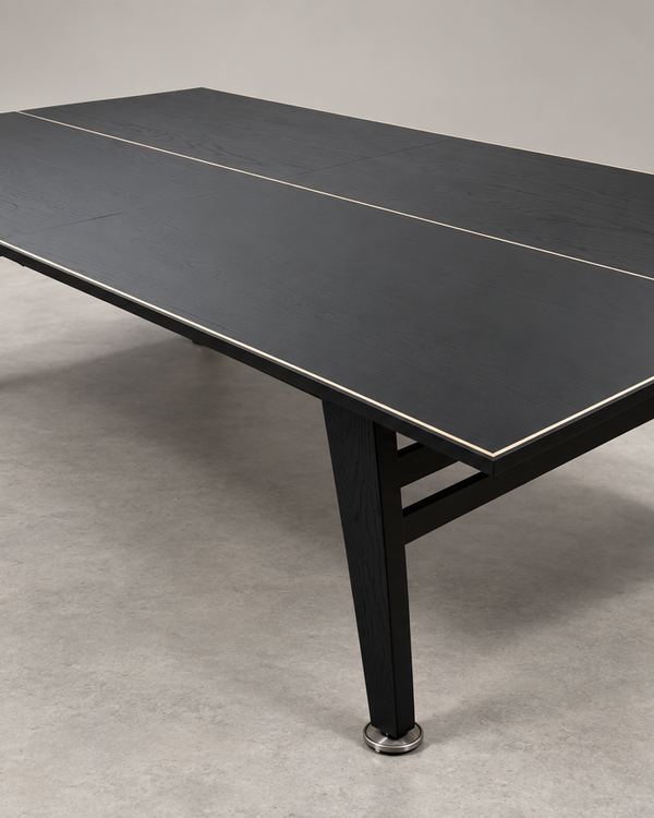 Custom black table tennis table with a light edge band and tapered legs